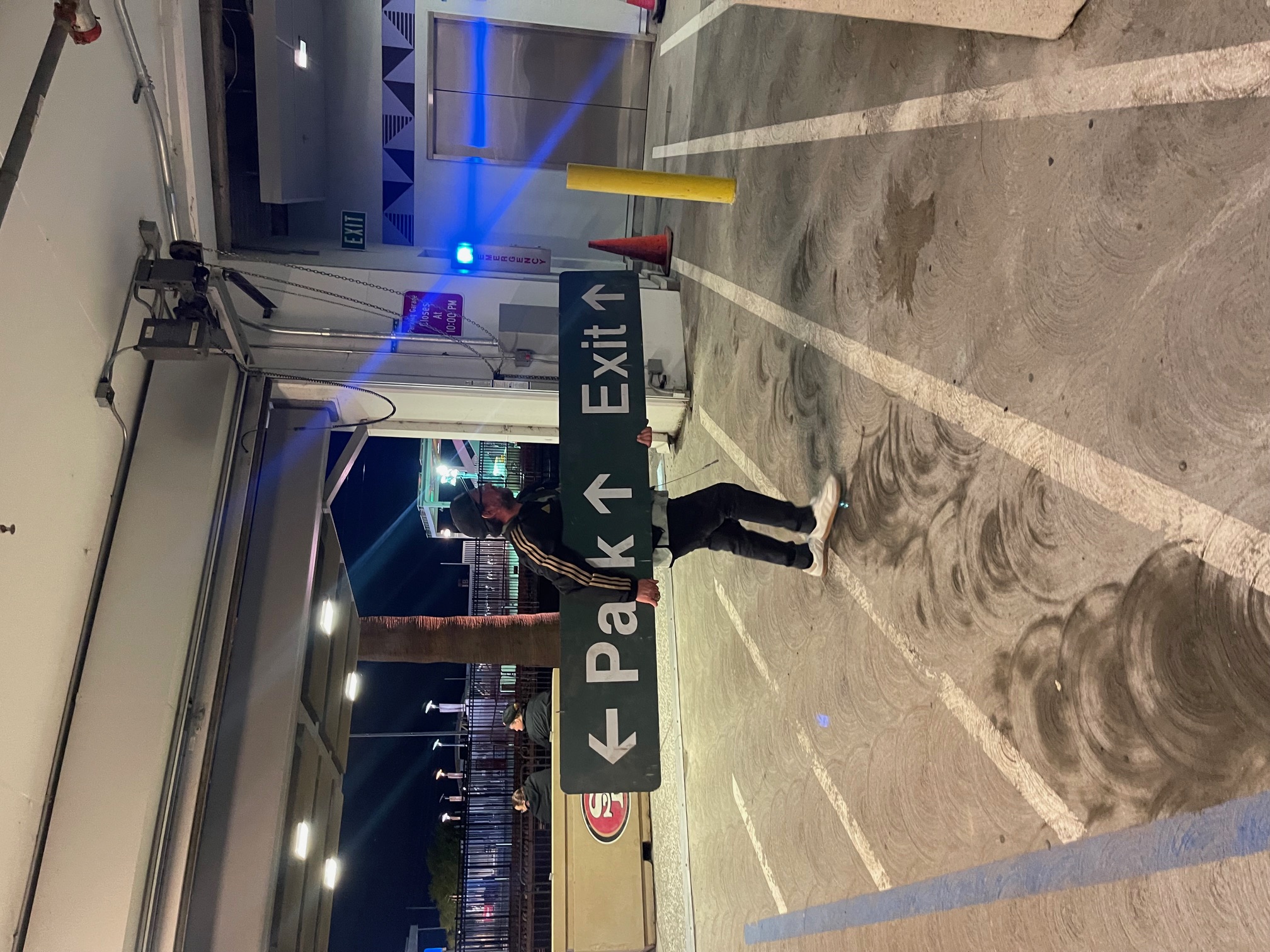 Joe walking with a sign he found after the LAFC match in San Jose